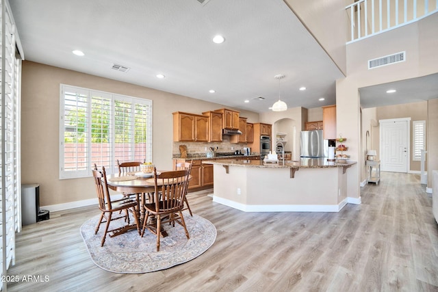 dining space featuring light hardwood / wood-style flooring and sink