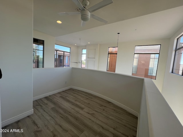 unfurnished room with hardwood / wood-style flooring and ceiling fan