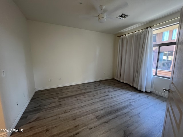 empty room with hardwood / wood-style floors and ceiling fan