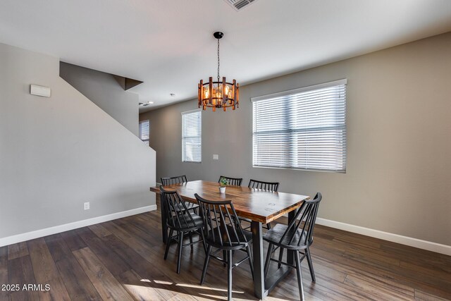 dining room featuring dark wood-type flooring and a notable chandelier