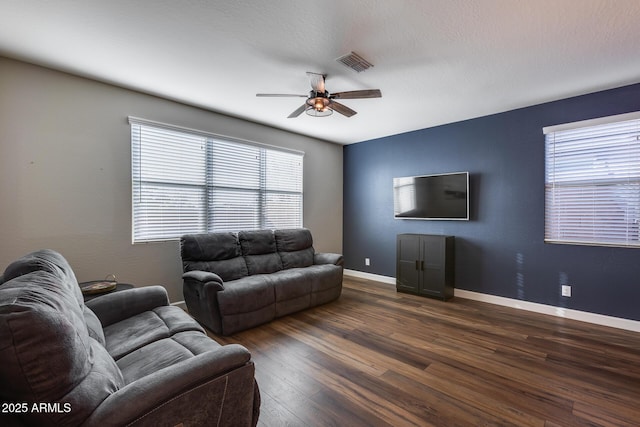 living room featuring ceiling fan and dark hardwood / wood-style flooring