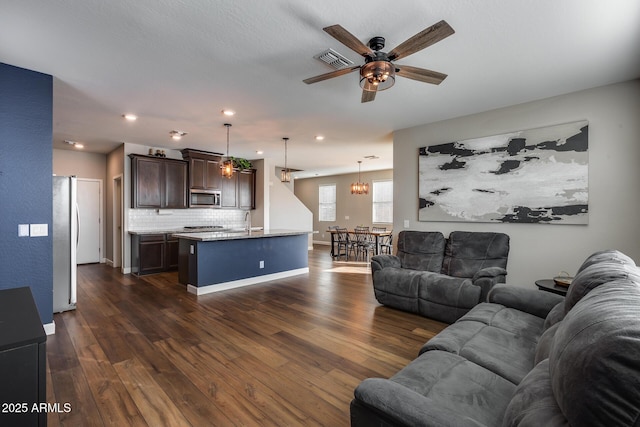 living room featuring dark hardwood / wood-style flooring, ceiling fan, and sink