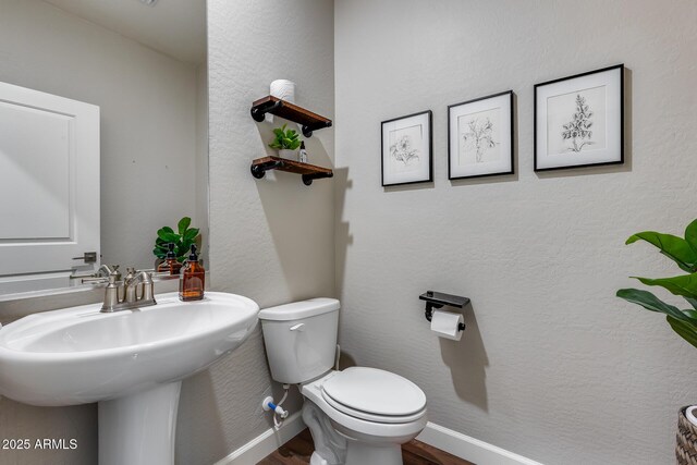 bathroom featuring toilet and sink