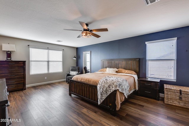 bedroom with ceiling fan and dark wood-type flooring