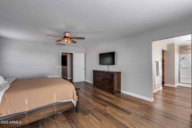 bedroom featuring connected bathroom, ceiling fan, dark hardwood / wood-style flooring, and a textured ceiling