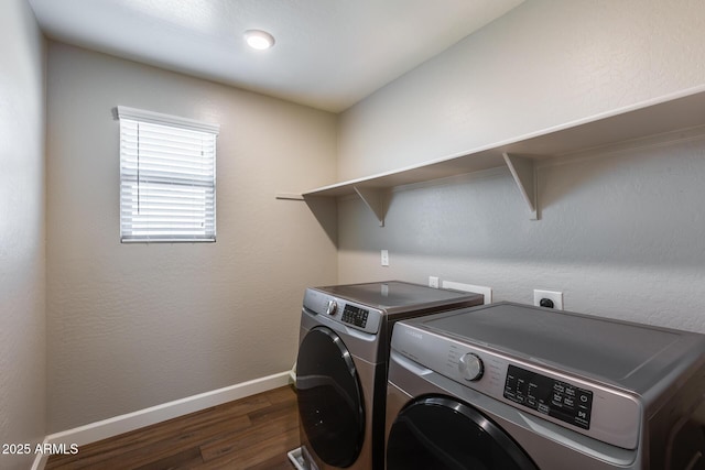 laundry area featuring washing machine and dryer and dark hardwood / wood-style floors