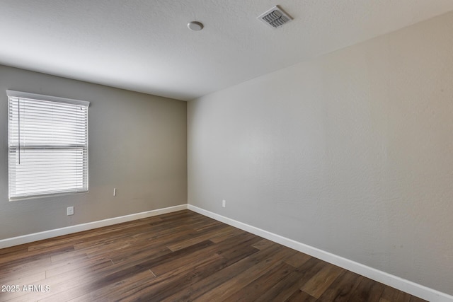 empty room featuring dark wood-type flooring