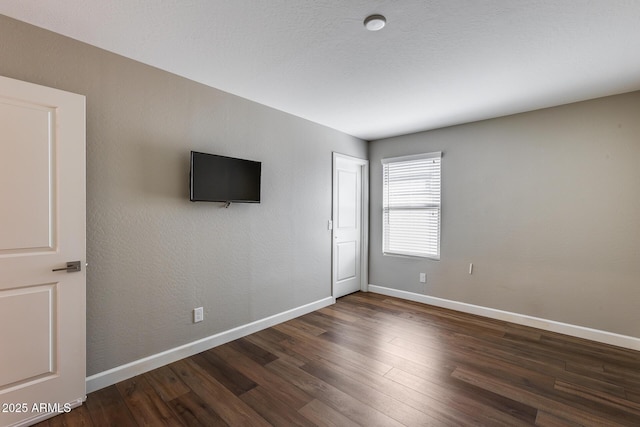 unfurnished room featuring dark hardwood / wood-style flooring