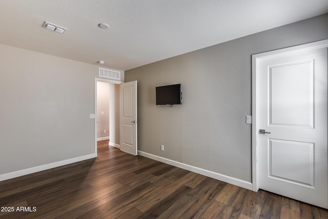 empty room with dark hardwood / wood-style floors