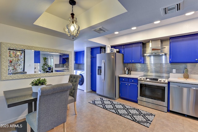 kitchen featuring stainless steel appliances, backsplash, hanging light fixtures, and blue cabinetry