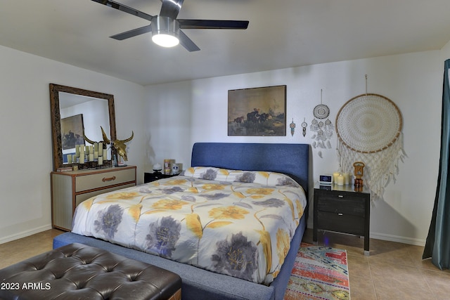 bedroom featuring tile patterned flooring, baseboards, and ceiling fan