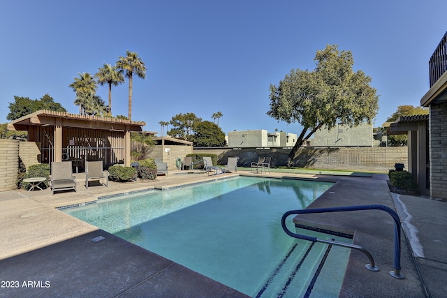 view of swimming pool featuring a fenced backyard, a patio area, and a fenced in pool