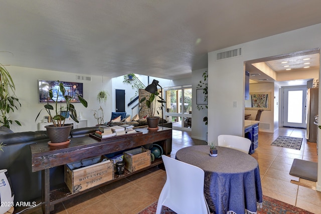 dining room with a healthy amount of sunlight and light tile patterned floors