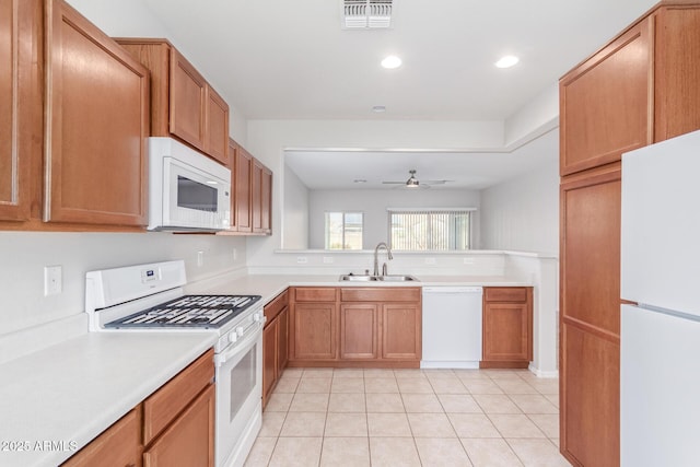 kitchen with ceiling fan, white appliances, sink, and light tile patterned floors