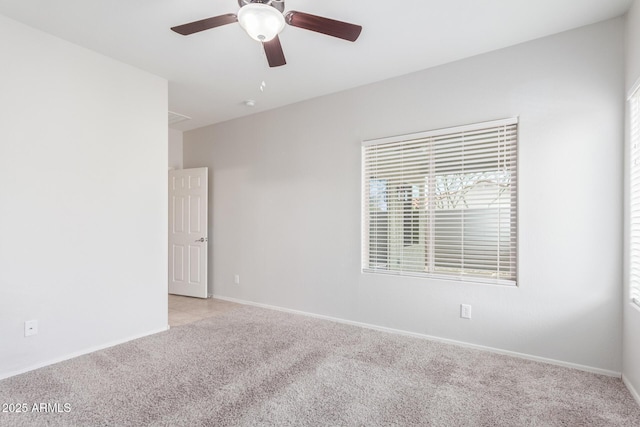 carpeted empty room featuring ceiling fan