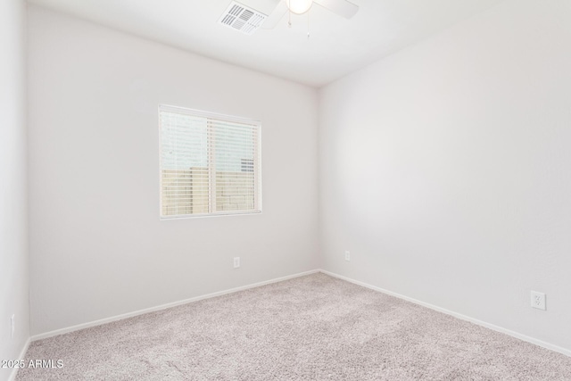 unfurnished room featuring ceiling fan and carpet