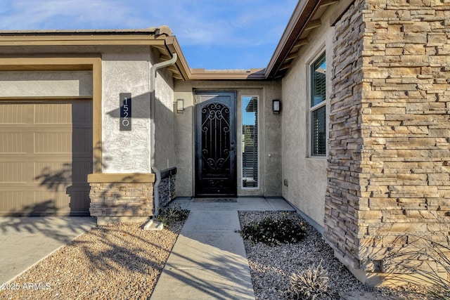 view of exterior entry featuring a garage