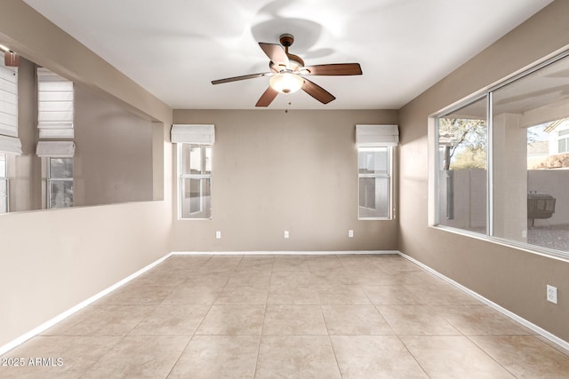 empty room with light tile patterned flooring and ceiling fan