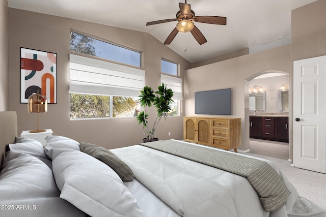 carpeted bedroom featuring lofted ceiling, ceiling fan, and connected bathroom