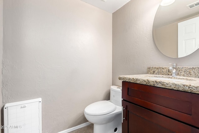 bathroom with toilet and vanity