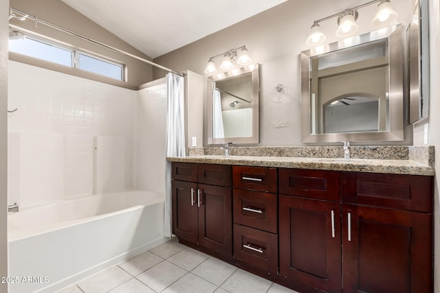 bathroom featuring tile patterned flooring, vaulted ceiling, shower / bath combo, and vanity