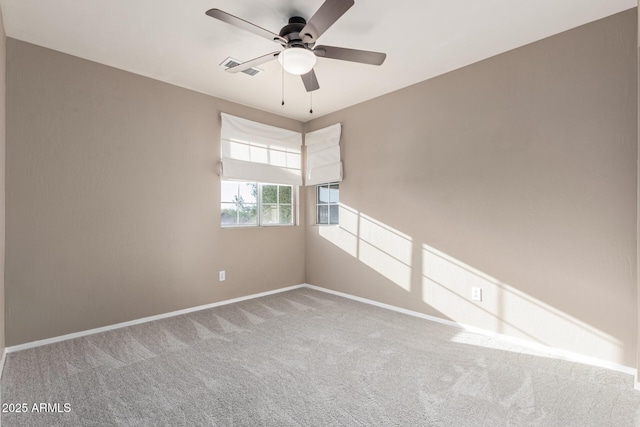 carpeted spare room featuring ceiling fan