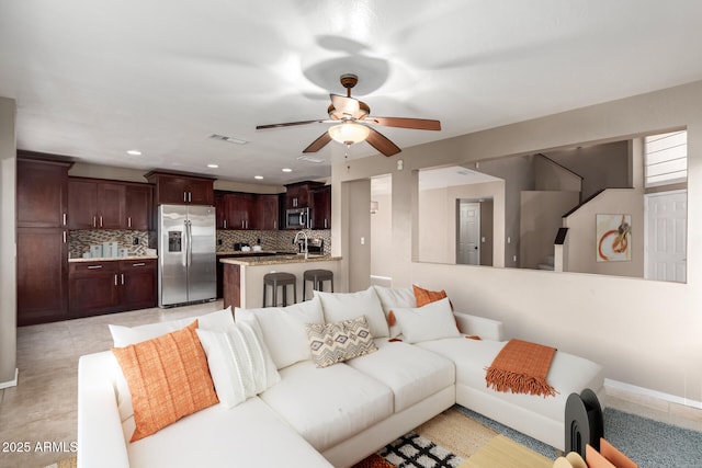 living room featuring sink and ceiling fan