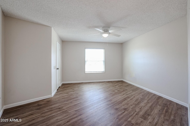 empty room featuring baseboards, wood finished floors, and ceiling fan