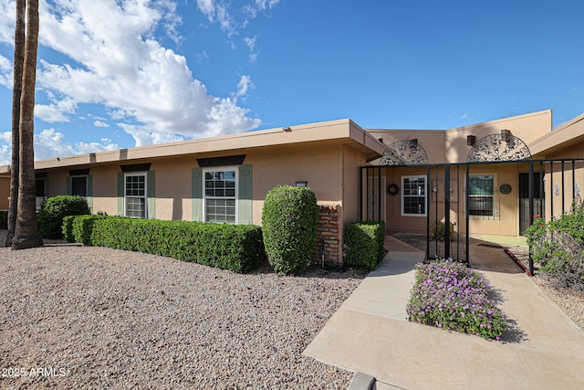 ranch-style home with stucco siding