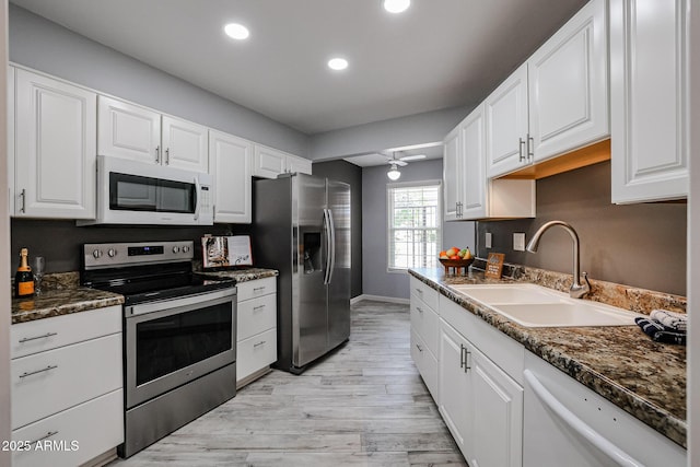 kitchen featuring a sink, ceiling fan, stainless steel appliances, white cabinetry, and recessed lighting