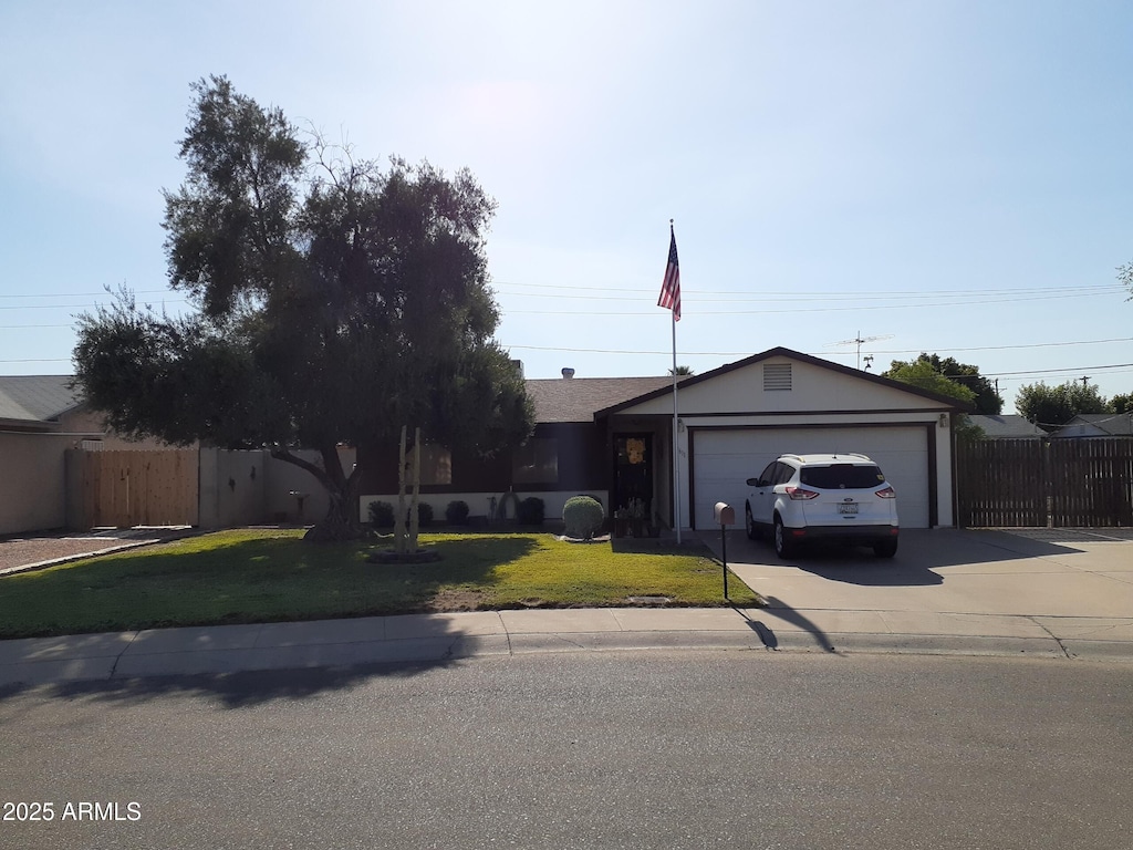 ranch-style home featuring a garage and a front yard