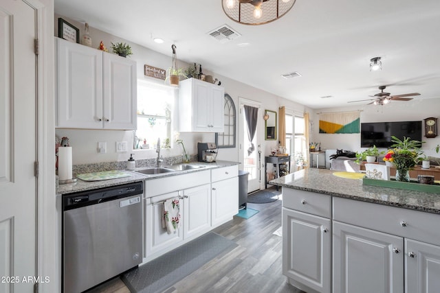 kitchen featuring white cabinetry, stainless steel dishwasher, and sink