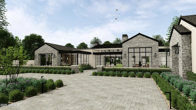 exterior space featuring stone siding and a chimney