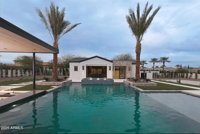 view of swimming pool with an outbuilding, a patio area, a pool with connected hot tub, and an exterior structure