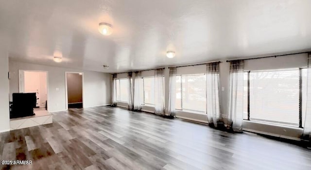 unfurnished living room featuring wood finished floors