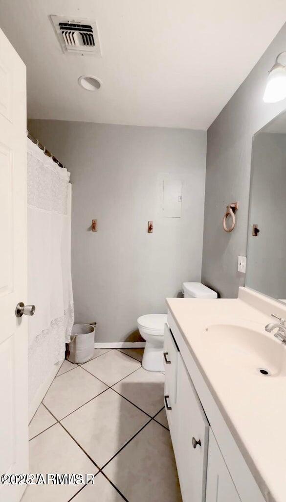 bathroom featuring tile patterned flooring, visible vents, toilet, and vanity