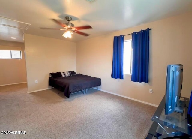 bedroom with baseboards, attic access, ceiling fan, and carpet flooring