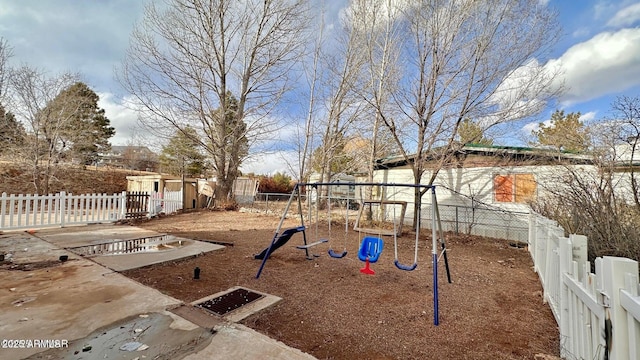 view of yard with playground community and fence