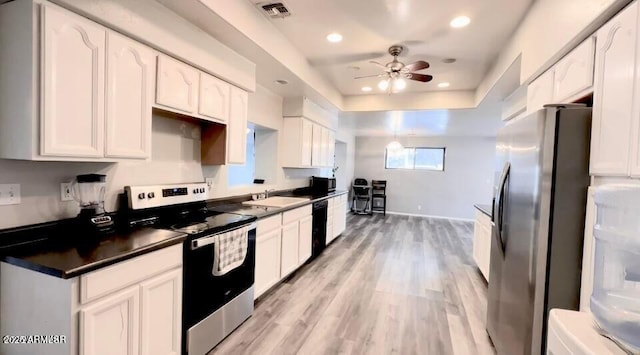 kitchen with visible vents, dark countertops, appliances with stainless steel finishes, and white cabinets