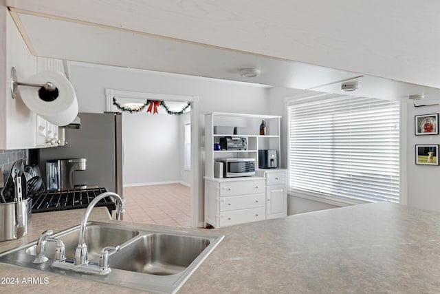 kitchen featuring white cabinetry, sink, and appliances with stainless steel finishes