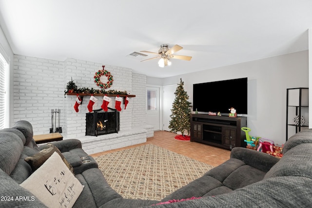 living room with a fireplace, ceiling fan, and light tile patterned flooring