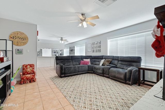 tiled living room with ceiling fan