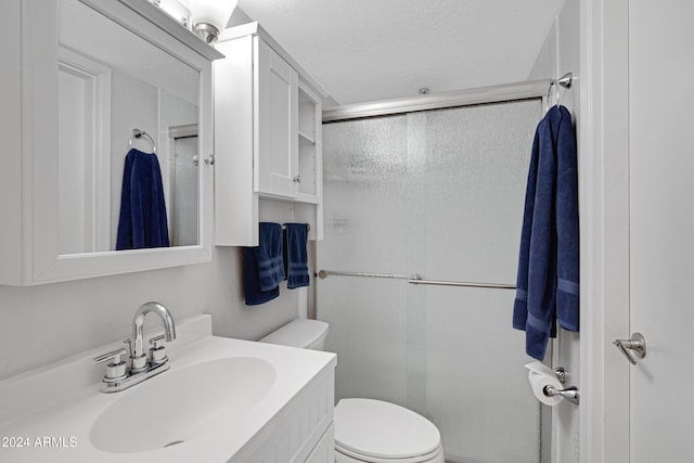 bathroom with vanity, toilet, and a textured ceiling