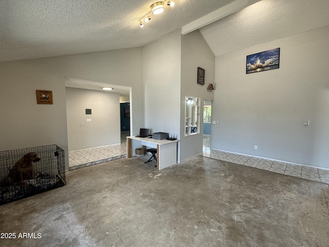 unfurnished living room with a textured ceiling, concrete flooring, and high vaulted ceiling