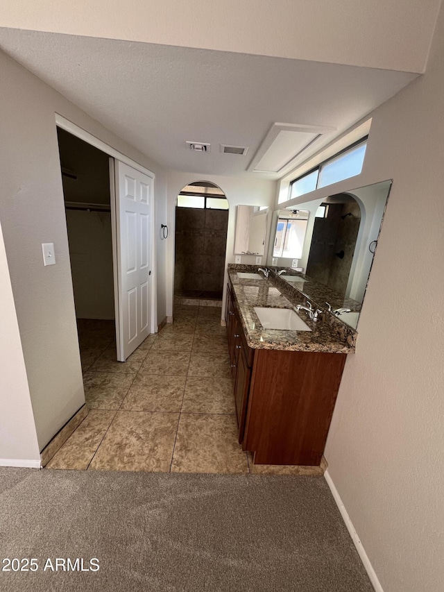 662 W Laguna Azul Ave, Mesa, AZ 85210 - bathroom with double vanity, carpet flooring, and tile patterned floors