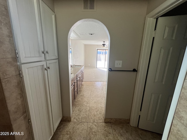 662 W Laguna Azul Ave, Mesa, AZ 85210 - hallway featuring arched walkways and light tile patterned floors
