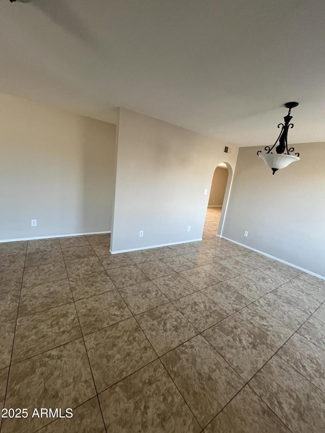 662 W Laguna Azul Ave, Mesa, AZ 85210 - tiled spare room with arched walkways and baseboards