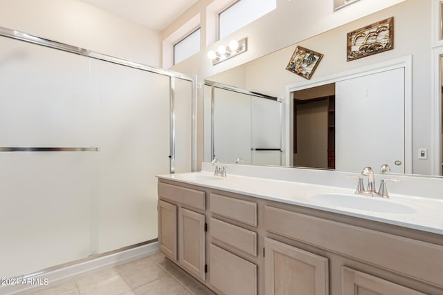 bathroom with vanity, a shower with door, and tile patterned floors