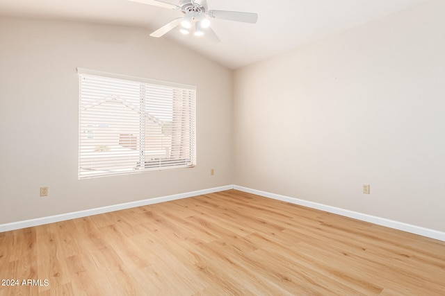 empty room featuring light hardwood / wood-style flooring, vaulted ceiling, and ceiling fan