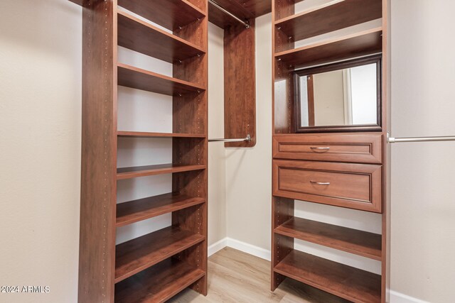 spacious closet with light hardwood / wood-style floors